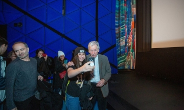 Costa-Gavras poses for a selfie with a young fan.